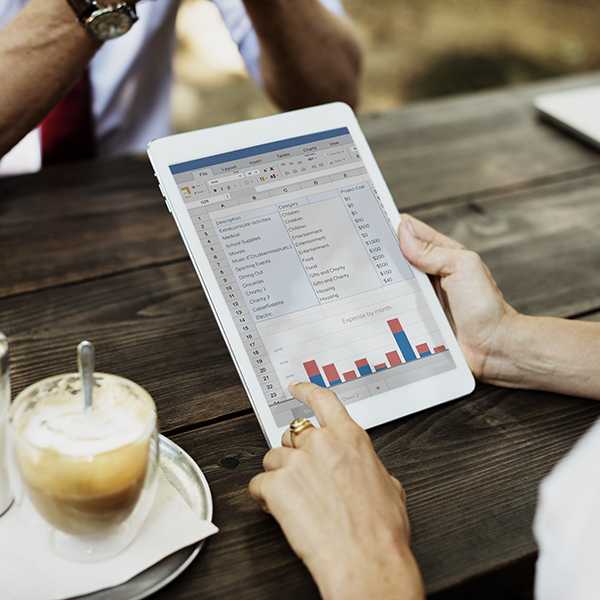 Women holding tablet with expense report